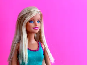 Which famous singer loves to play with Barbie™ dolls?