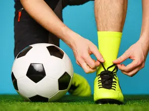 Why did the footballer hold his boot to his ear?