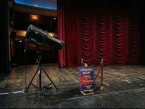 Why did the theater spotlight stop working on opening night?