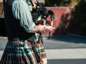 Why do bagpipe players walk when they play?