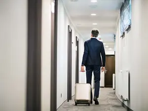 Why do managers bring suitcases along to away games?